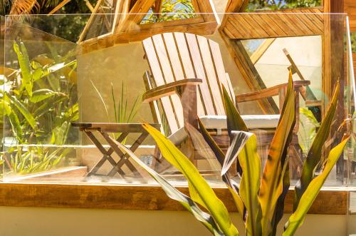 a wooden chair sitting in a window next to a plant at Santuario Yelapa in Yelapa