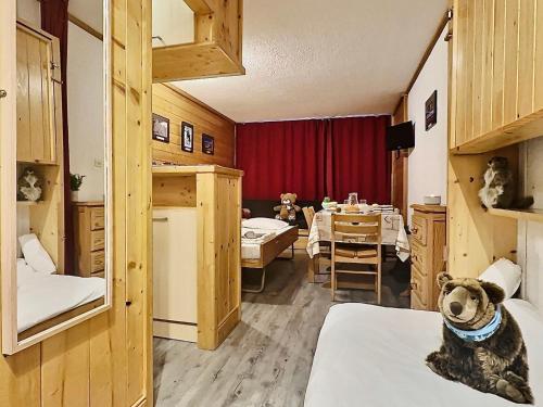 une chambre avec 2 chiens assis sur des lits et une salle à manger dans l'établissement Charmant studio 4 pers. à Tignes Val Claret, pied des pistes, balcon sud, proche commerces - FR-1-411-462, à Tignes