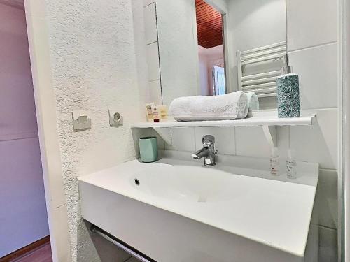 a white bathroom with a sink and a mirror at Studio Tignes, 1 pièce, 4 personnes - FR-1-411-480 in Tignes