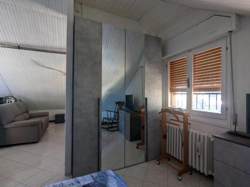 a living room with a couch and a window at Casa 2112 in Sestola