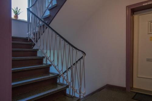 a staircase in a building with a stair railing at Private Rooms in Hannover