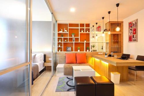 a living room with a couch and a desk at Greenery living in resort condo in Chiang Mai