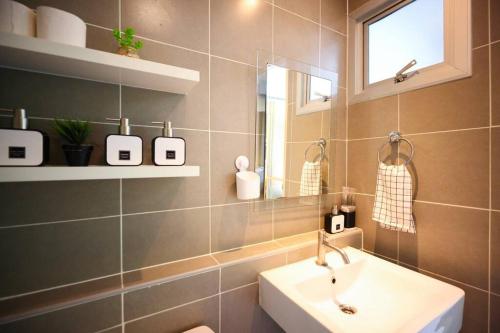 a bathroom with a sink and a mirror at Greenery living in resort condo in Chiang Mai