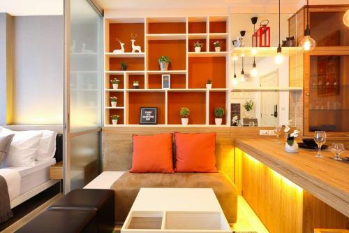 a living room with a couch and a table at Greenery living in resort condo in Chiang Mai