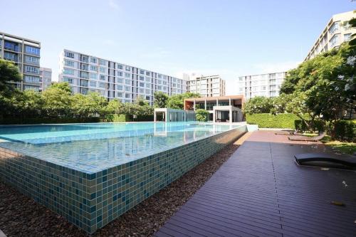 a swimming pool in the middle of a building at Greenery living in resort condo in Chiang Mai