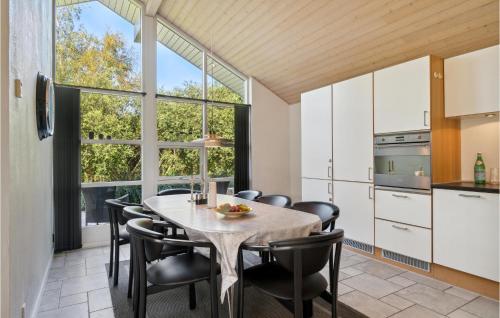 a kitchen and dining room with a table and chairs at Holiday Home Sivsangervej Ebeltoft Iii in Øksenmølle