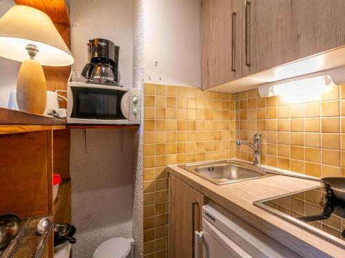 a small kitchen with a sink and a microwave at Studio Val-d'Isère, 1 pièce, 4 personnes - FR-1-694-209 in Val-d'Isère