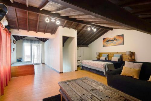 a living room with a bed and a couch at Alojamento Lagoa in Lagoa