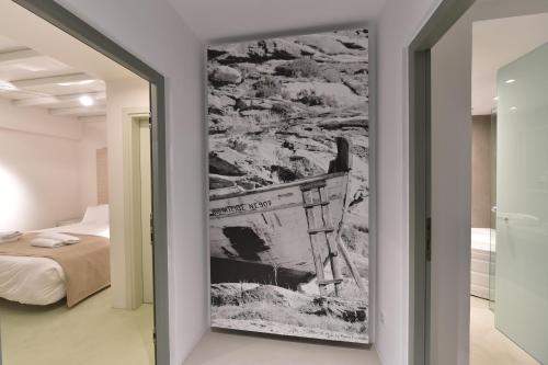 a painting on a wall in a room with a bed at Hotel Senia - Onar Hotels Collection in Naousa