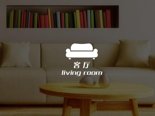 a living room with a table with a hat on a couch at Lumpini Makkasan Elit Condo in Bangkok