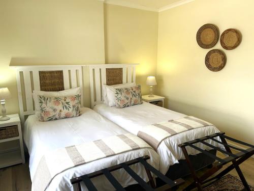 a bedroom with two beds with pillows on them at Adrenalin Addo Manor House in Addo