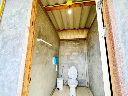 a bathroom with a toilet in a small room at Check in Lanta in Ko Lanta