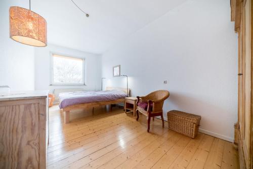 a bedroom with a bed and a table and a chair at Private Rooms in Hannover