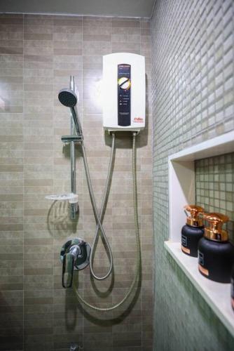a shower in a bathroom with a blow dryer at Luxury Living in heart of Nimman in Chiang Mai