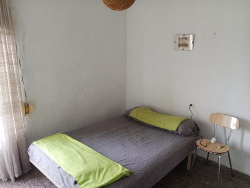 アリカンテにあるPensíon24Todoの小さなベッドルーム(ベッド1台、サイドテーブル付)