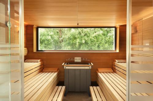 a sauna with wood paneling and a window at Park Igls - Medical Spa Resort in Innsbruck