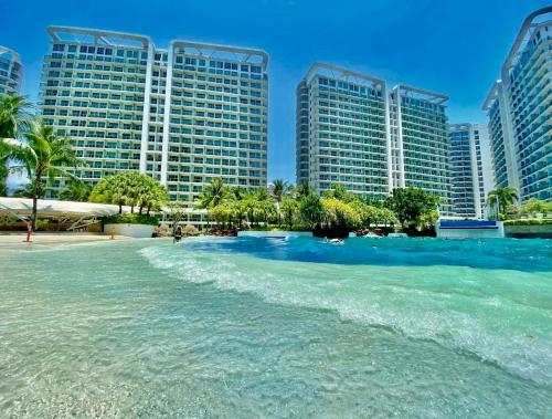 a beach in front of some tall buildings at Azure Urban Beach Resort Residences in Manila