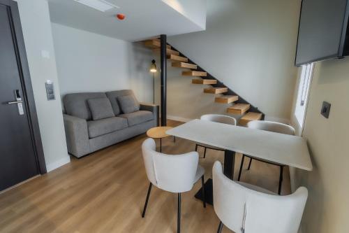 a living room with a table and chairs and a couch at HOTEL CORONA DE PADRÓN in Padrón