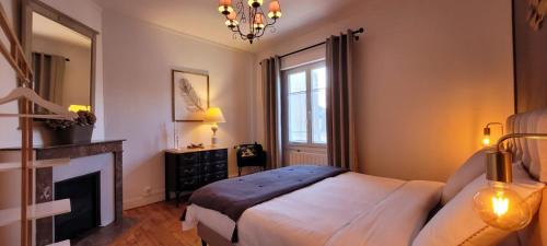 a bedroom with a bed and a fireplace at Maison de ville avec patio in Trouville-sur-Mer