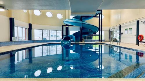 a swimming pool with a slide in the middle of it at Holiday Inn Sydney - Waterfront by IHG in Sydney