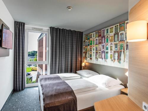 Postel nebo postele na pokoji v ubytování B&B Hotel Lübeck