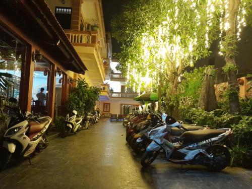 a row of motorcycles parked outside of a building at Lys Homestay in Ninh Binh