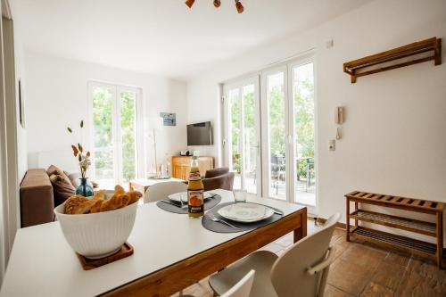 eine Küche und ein Wohnzimmer mit einem Tisch und Stühlen in der Unterkunft DER STÖRTEBEKER - "Apartment Wieck" Apartments hinter den Dünen in Dierhagen