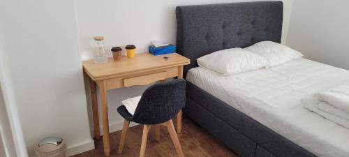 a bed and a desk with a chair next to a bed at Comfy room near Metro and Airport in Lisbon