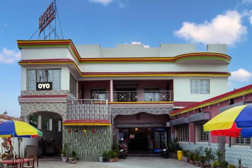 a building with an omg sign on top of it at OYO Flagship Raj Munmun Hotel in Dhanbād