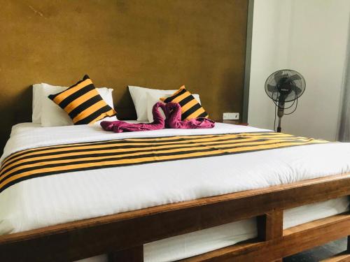 a large bed with two stuffed animals on it at Monarch Ella in Ella