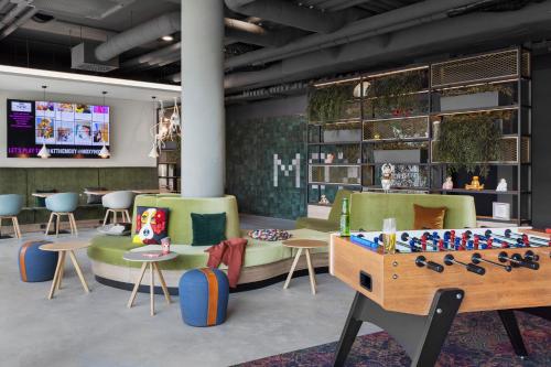 a room with a table and chairs and a chessboard at Moxy Vienna City East in Vienna