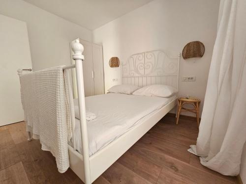 a bedroom with a white bed with a white canopy at Vila Regina Apartment Rex with Swimming Pool in Jezera