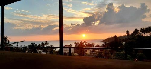 a view of the ocean from a balcony at sunset at X Mirissa in Mirissa