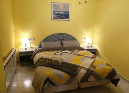 a bedroom with a large bed with two night stands at Panorama3 in Altea la Vieja