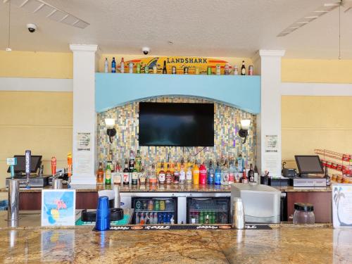 a bar with a tv on a wall in a store at 3Br 2Bath Condo Balcony 5min Conv Center 1388ft in Orlando