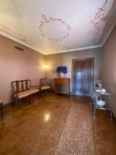 an empty room with two chairs and a ceiling at Palazzetto Pisani Grand Canal in Venice