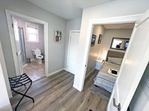 a room with a bed and a bathroom with a toilet at Hamilton Mountain Plaza - Smart Home - Main Floor in Hamilton