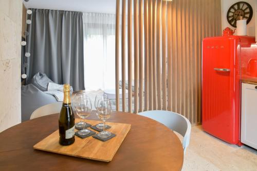 a table with a bottle of wine and glasses on it at Rock Garden Apartment in Arco