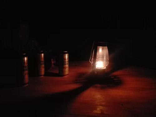 a lit candle sitting on a table in the dark at LIFE OF COCO in Galge