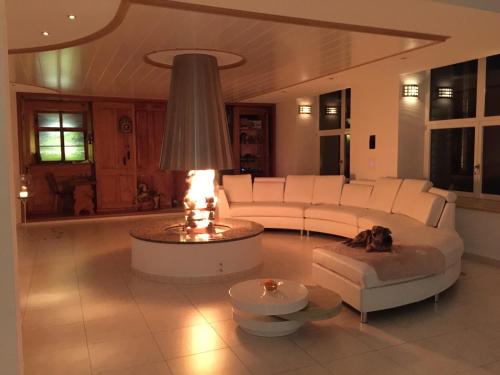 a living room with a white couch and a table at Luxus-Loft Atrium -X- in Rorbas