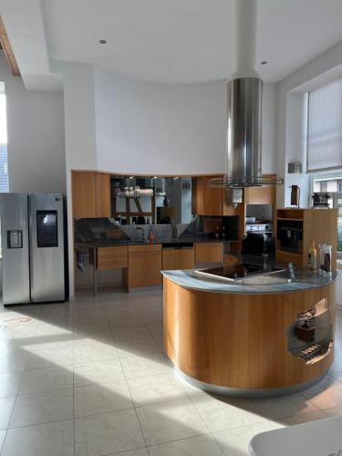 a kitchen with a circular counter in the middle at Luxus-Loft Atrium -X- in Rorbas