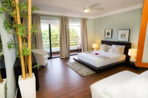 a hotel room with a bed and a balcony at RIBERAMAR Las Terrenas, Samana in Las Terrenas
