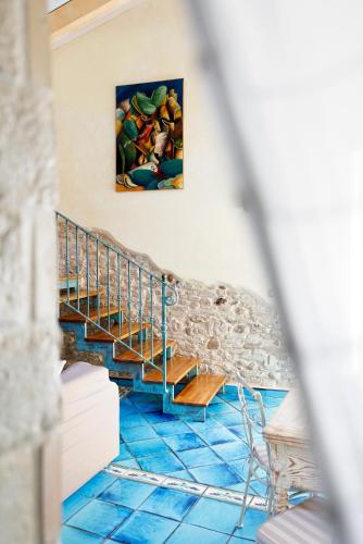 a room with blue tile floors and a painting on the wall at Residenza Sveva in Termoli