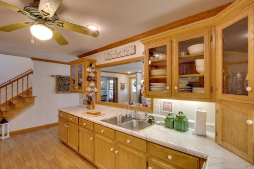 a kitchen with a sink and a ceiling fan at Waterfront Home Near Wilson Lake with Covered Porch! in Killen