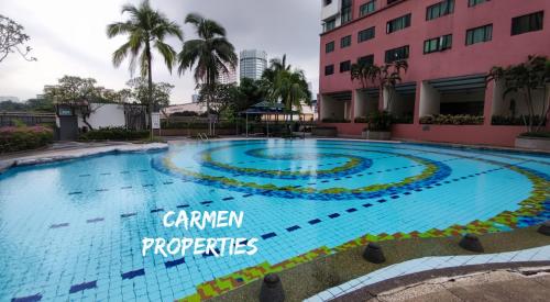 a swimming pool in front of a building with the sign garden properties at Bistari Single Room, FEMALE guests only, Free wifi in Kuala Lumpur