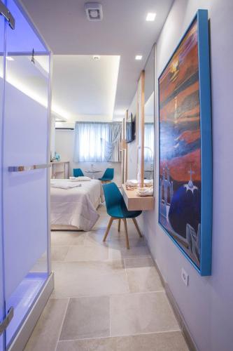 a bedroom with a bed and a desk and a painting at Mariet Athens Boutique Spa in Athens