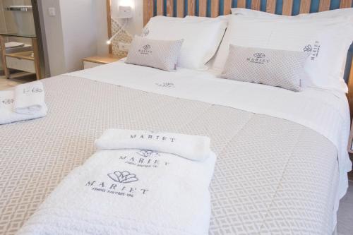 a bed with white towels on top of it at Mariet Athens Boutique Spa in Athens