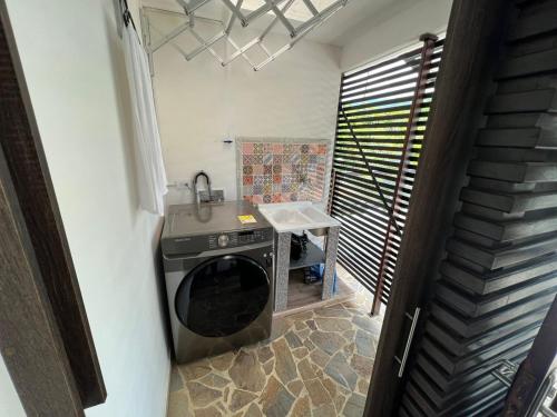 eine Waschmaschine in einer Küche mit Spüle in der Unterkunft Hermosa cabaña en sopetran in Sopetran