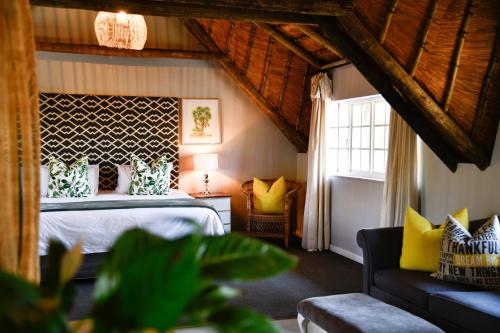 a bedroom with a bed with yellow pillows at Gowan Valley Guest Farm in Balgowan