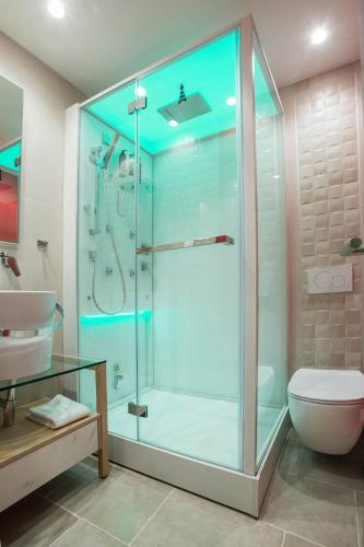 a bathroom with a shower with a sink and a toilet at Mariet Athens Boutique Spa in Athens